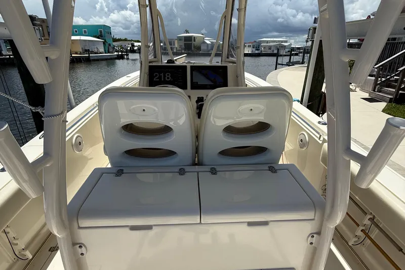 Slide: The Image of 2015 Cobia 296 Center Console boat interior with dual seats and navigation display. - 16