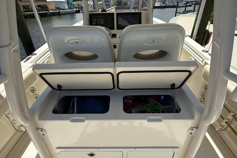 Slide: The Image of 2015 Cobia 296 Center Console boat interior with open storage compartments. - 17