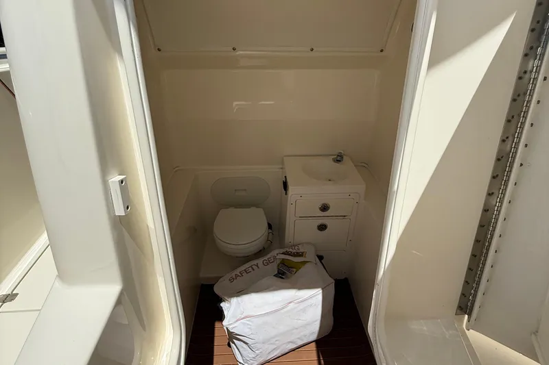 Slide: The Image of Interior of 2015 Cobia 296 Center Console boat with toilet and sink. - 21