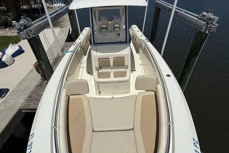 Slide: The Image of 2015 Cobia 296 Center Console boat docked, featuring spacious seating and sleek design. - 28
