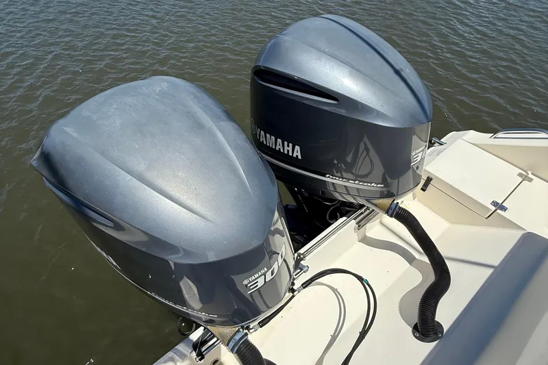 Slide: The Image of Twin Yamaha outboard engines on a 2015 Cobia 296 Center Console boat. - 31