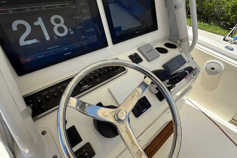 Slide: The Image of 2015 Cobia 296 Center Console helm with Garmin displays and Yamaha steering wheel. - 6