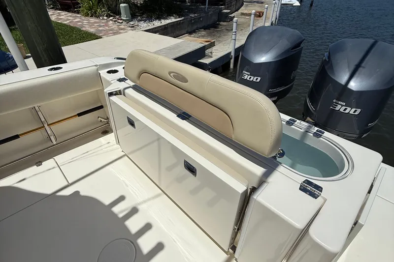 Slide: The Image of 2015 Cobia 296 Center Console boat with Yamaha 300 engines, featuring a livewell and seating. - 8