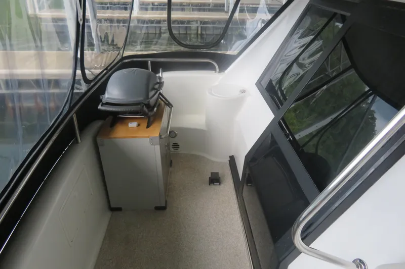 Slide: The Image of 2000 Bluewater Yachts 5800 interior with grill and seating area. - 10