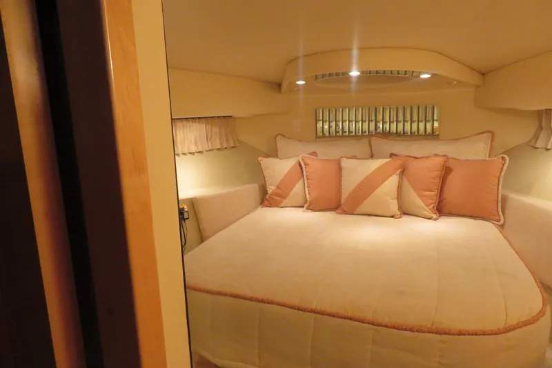 Slide: The Image of Cozy bedroom interior of 2000 Bluewater Yachts 5800 with elegant pillows and soft lighting. - 13