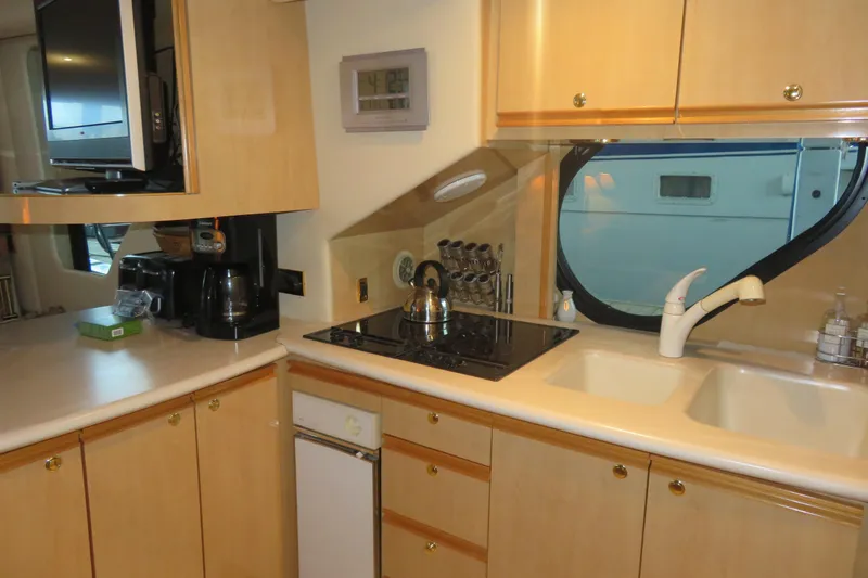 Slide: The Image of Modern kitchen in 2000 Bluewater Yachts 5800, featuring stove, sink, and cabinetry. - 17