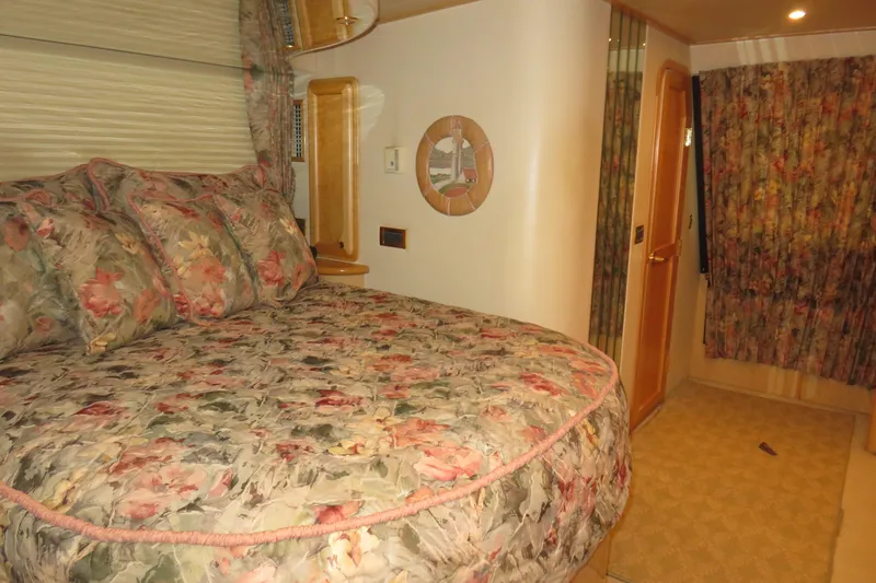 Slide: The Image of Luxurious bedroom interior of 2000 Bluewater Yachts 5800 with floral decor. - 18