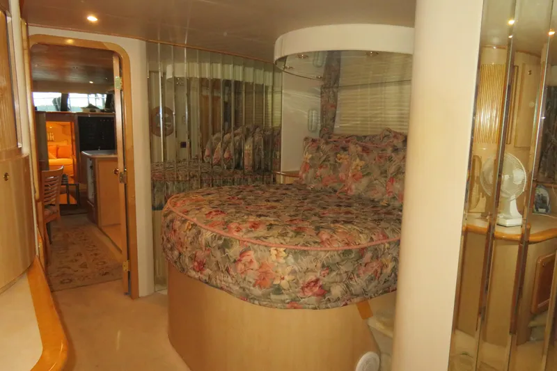 Slide: The Image of Luxurious bedroom interior of 2000 Bluewater Yachts 5800 with floral bedding and elegant decor. - 21