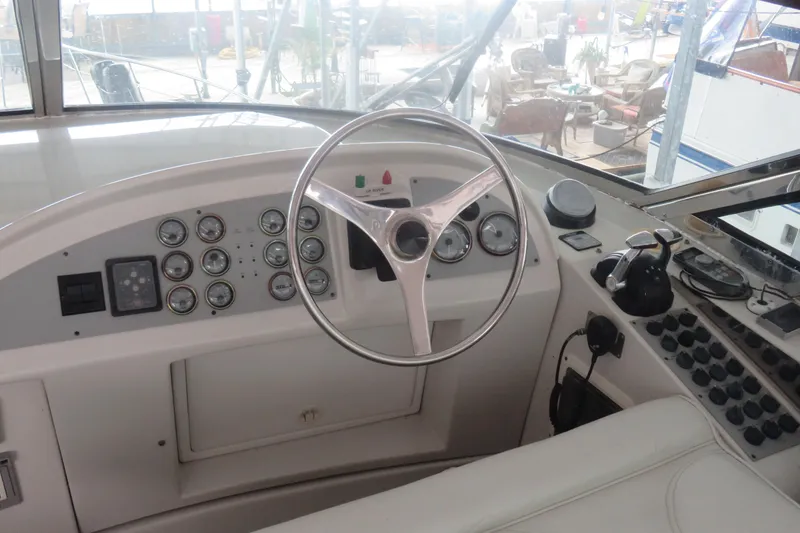 Slide: The Image of Cockpit of 2000 Bluewater Yachts 5800 with steering wheel and control panel. - 3