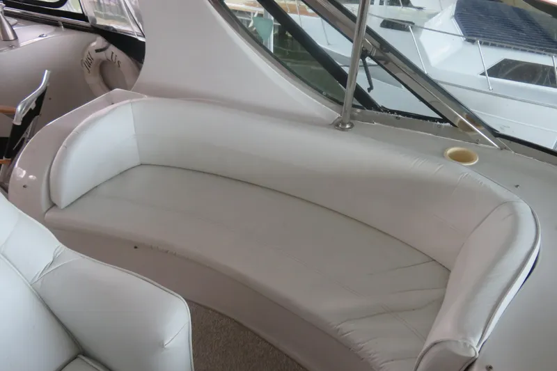 Slide: The Image of White leather seating on a 2000 Bluewater Yachts 5800 interior. - 5