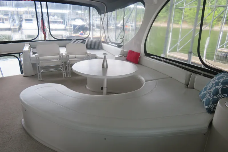 Slide: The Image of Luxurious interior of 2000 Bluewater Yachts 5800 with elegant seating and scenic marina view. - 6