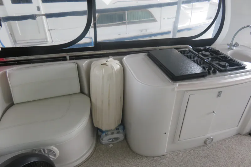 Slide: The Image of Interior of 2000 Bluewater Yachts 5800 featuring seating, stove, and sink. - 7