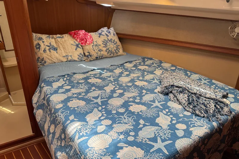 Slide: The Image of Cozy cabin bedroom in 2004 Island Packet 420 yacht with nautical-themed bedding. - 11
