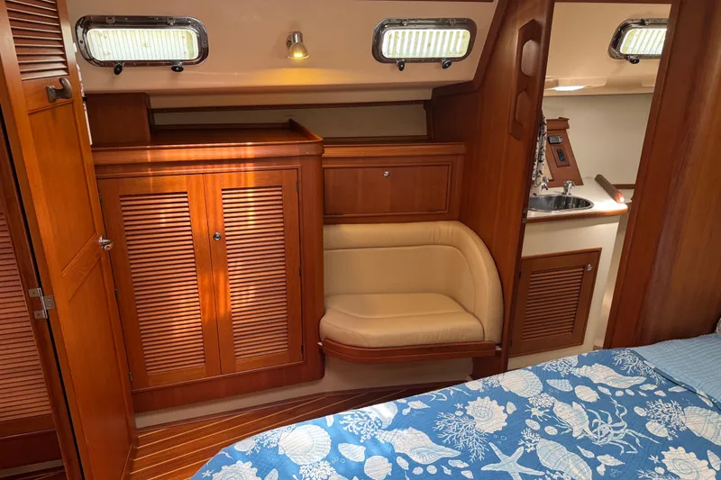 Slide: The Image of Interior of 2004 Island Packet 420 yacht with wood cabinetry and cozy seating area. - 12