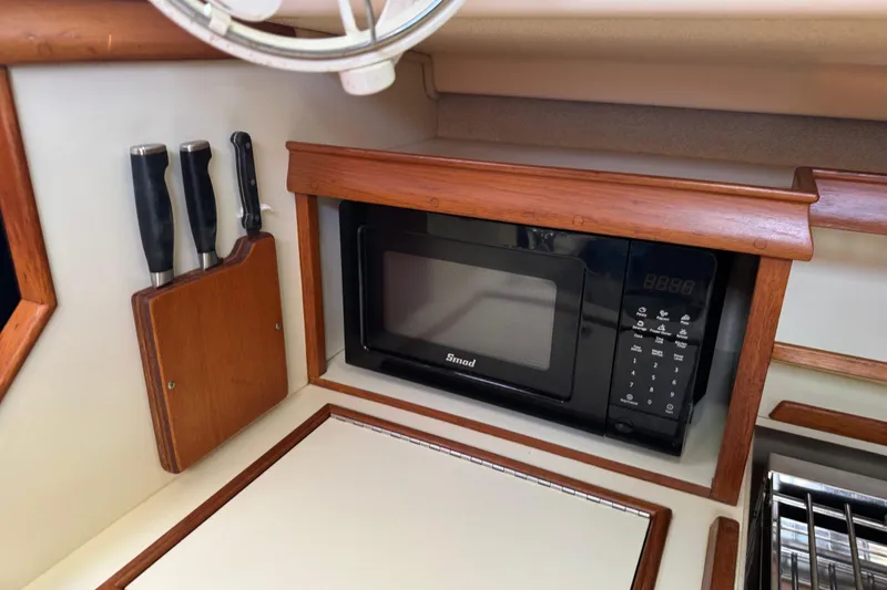 Slide: The Image of 2004 Island Packet 420 yacht kitchen with microwave and knife set. - 22