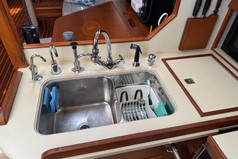 Slide: The Image of Galley sink in 2004 Island Packet 420 yacht with dish rack and sponges. - 25