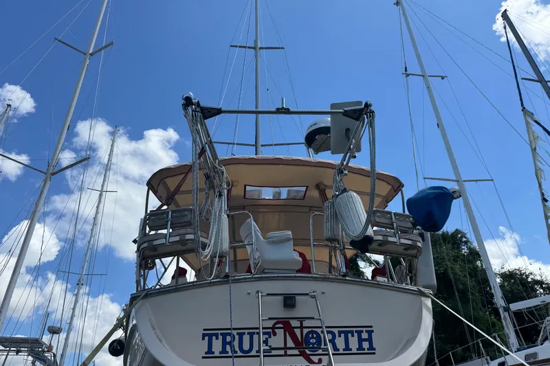 Slide: The Image of 2004 Island Packet 420 sailboat docked under a clear blue sky. - 34