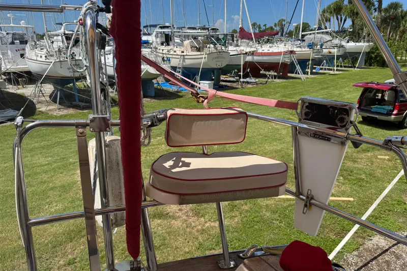 Slide: The Image of 2004 Island Packet 420 sailboat with cushioned seating, docked among other boats. - 36