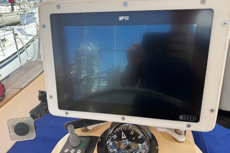 Slide: The Image of Navigation equipment on 2004 Island Packet 420 sailboat, featuring a compass and display screen. - 38