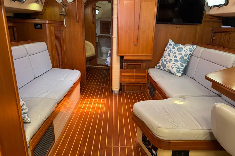 Slide: The Image of Luxurious 2004 Island Packet 420 yacht interior with wooden flooring and comfortable seating. - 4