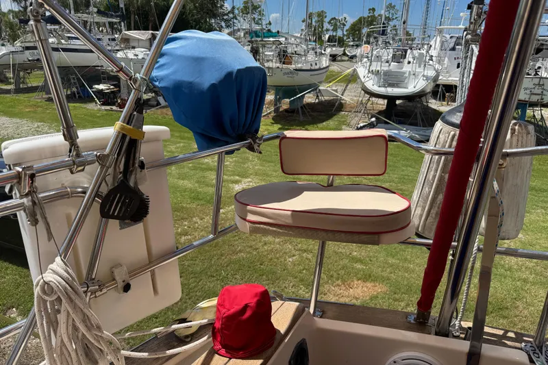 Slide: The Image of 2004 Island Packet 420 sailboat deck with seating and marina view. - 40