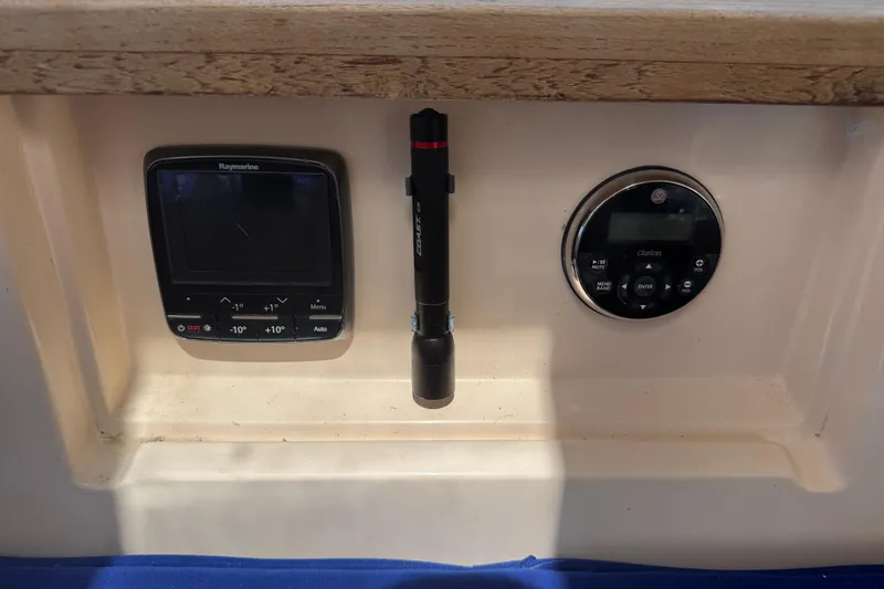 Slide: The Image of Control panel of a 2004 Island Packet 420 with Raymarine display and Clarion audio system. - 41