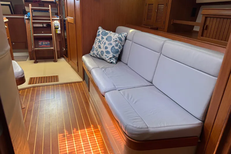 Slide: The Image of Interior of 2004 Island Packet 420 yacht with cushioned seating and nautical decor. - 5