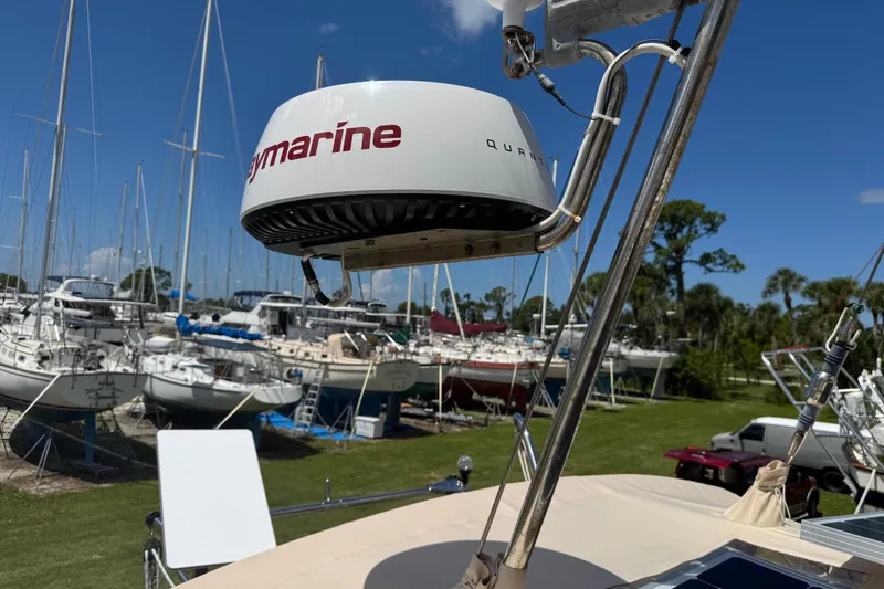 Slide: The Image of Radar equipment on a 2004 Island Packet 420 sailboat, docked among other vessels. - 52