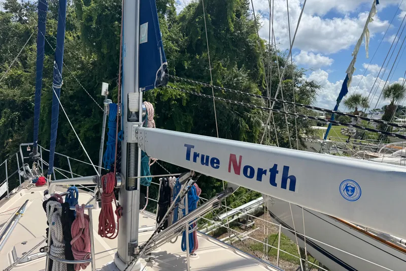 Slide: The Image of 2004 Island Packet 420 sailboat deck with mast and rigging, labeled "True North." - 56
