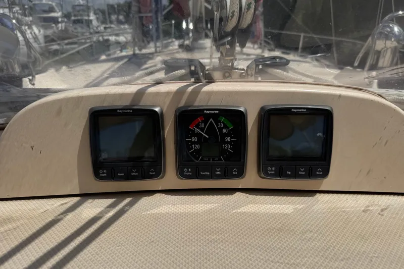 Slide: The Image of Raymarine instrument panel on 2004 Island Packet 420 sailboat, displaying navigation data. - 57