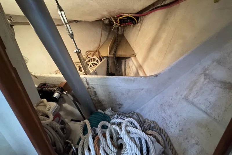 Slide: The Image of Interior of 2004 Island Packet 420 sailboat showing ropes and anchor chain storage. - 58