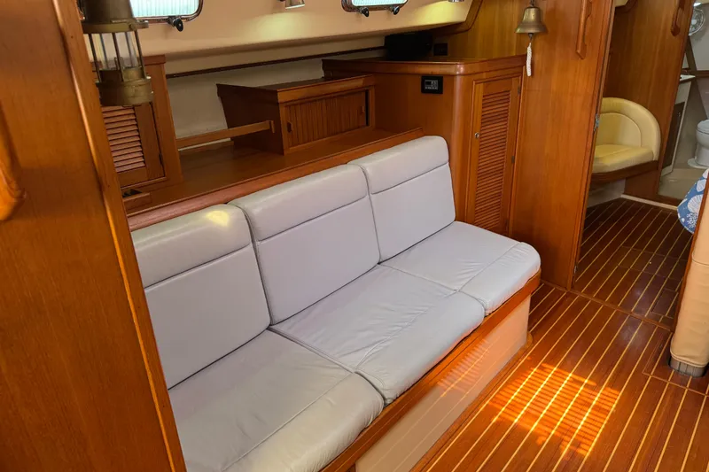 Slide: The Image of Interior of 2004 Island Packet 420 yacht with wooden flooring and cushioned seating. - 6