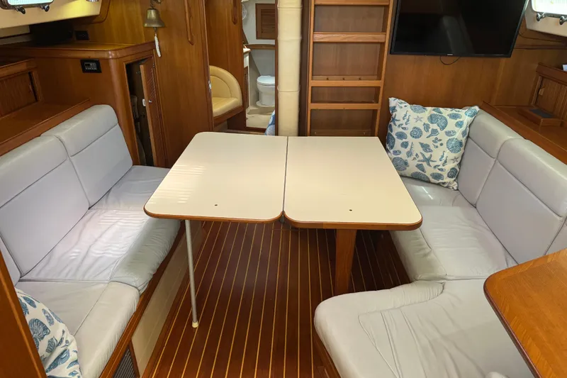 Slide: The Image of Interior of 2004 Island Packet 420 yacht with cozy seating and dining area. - 8