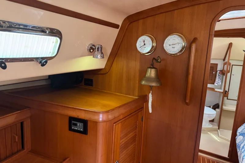 Slide: The Image of Interior of 2004 Island Packet 420 yacht with wooden cabinetry and nautical instruments. - 9