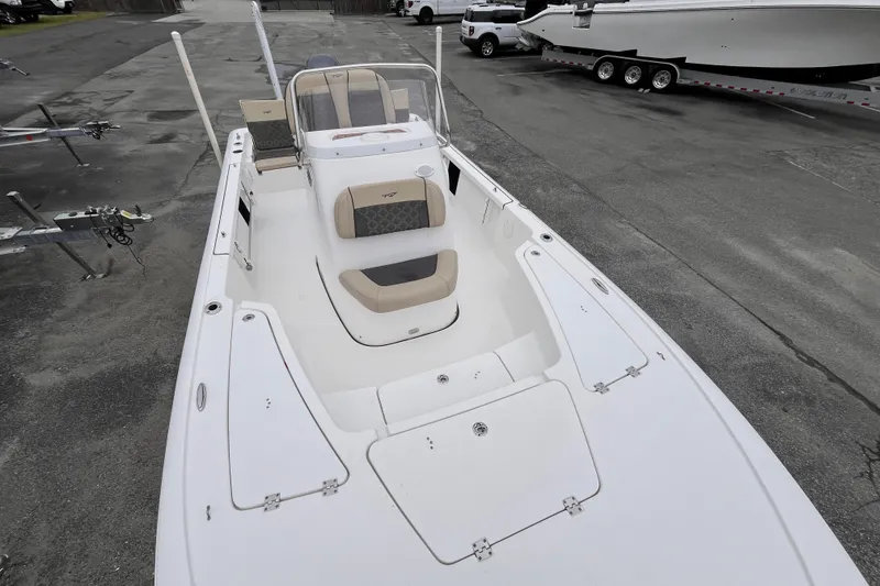 Slide: The Image of 2022 Tidewater 2110 Bay Max boat, white exterior, parked on a trailer in a lot. - 10