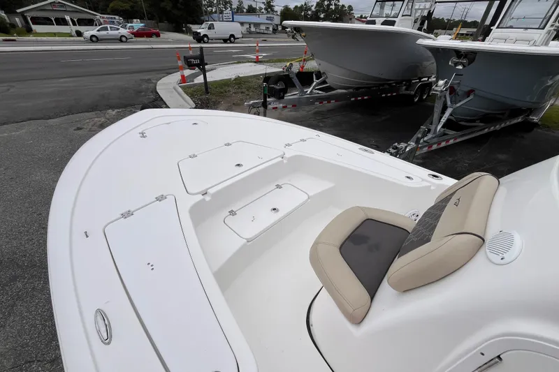 Slide: The Image of 2022 Tidewater 2110 Bay Max boat on display, featuring spacious deck and seating. - 11