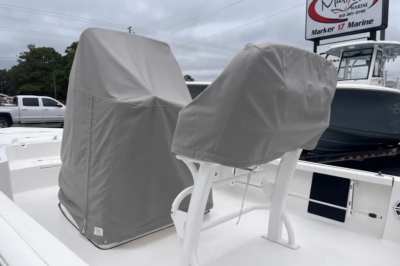 Slide: The Image of 2022 Tidewater 2110 Bay Max boat with covered console and seating at a marina. - 16