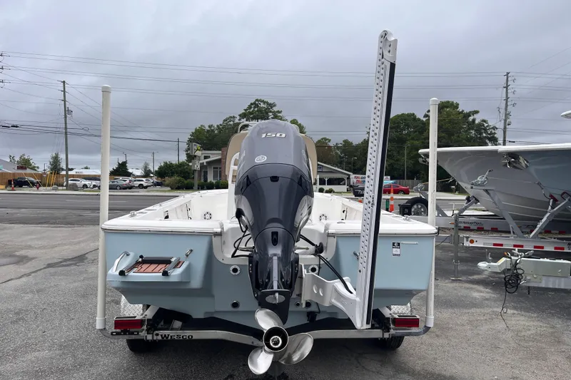 Slide: The Image of 2022 Tidewater 2110 Bay Max boat with outboard motor, parked on a trailer. - 3
