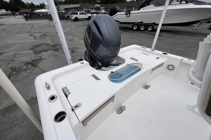 Slide: The Image of 2022 Tidewater 2110 Bay Max boat with Yamaha outboard motor in a marina setting. - 5