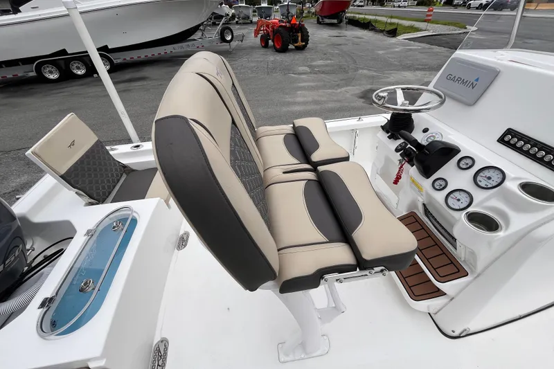 Slide: The Image of 2022 Tidewater 2110 Bay Max boat interior with beige seating and Garmin navigation system. - 7