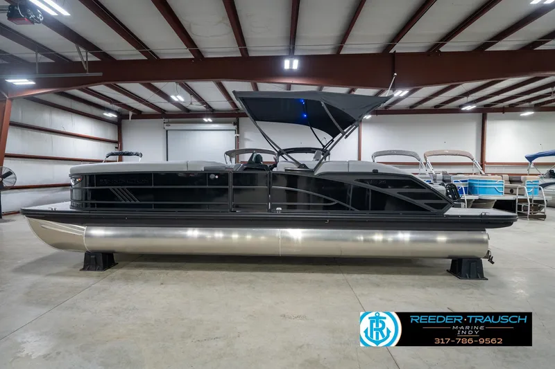 Slide: The Image of 2026 Bennington 26 MSB pontoon boat in showroom, featuring sleek design and modern amenities. - 10