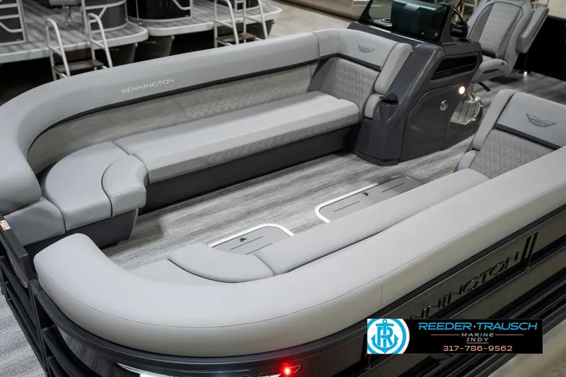 Slide: The Image of 2026 Bennington 26 MSB pontoon boat in indoor showroom with canopy. - 11