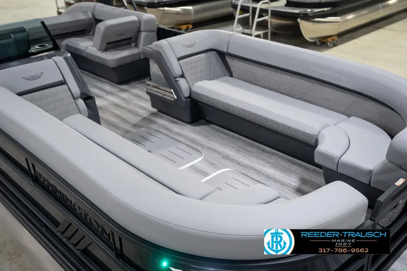 Slide: The Image of 2026 Bennington 26 MSB pontoon boat in showroom, featuring sleek design and modern amenities. - 12