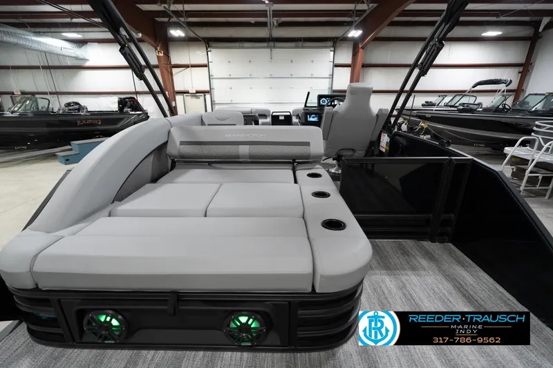 Slide: The Image of 2026 Bennington 26 MSB boat interior with luxurious seating and modern design in showroom. - 18