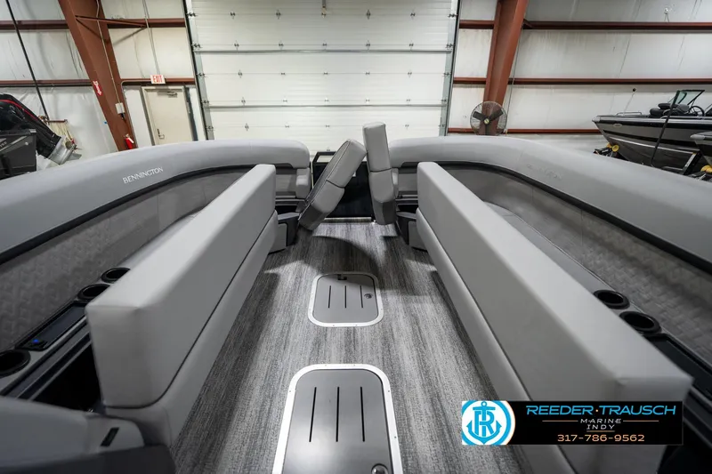 Slide: The Image of 2026 Bennington 26 MSB boat interior with modern dashboard and seating in a showroom. - 21