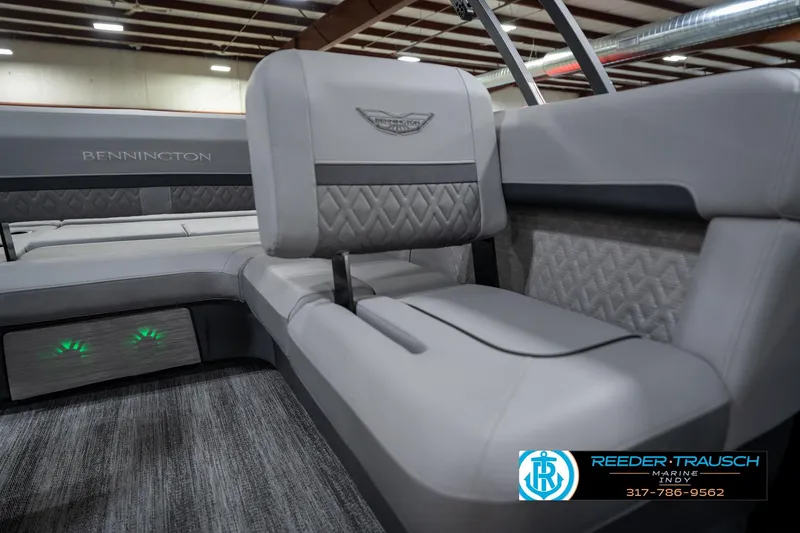 Slide: The Image of 2026 Bennington 26 MSB boat interior with gray seating and flooring in a showroom. - 22