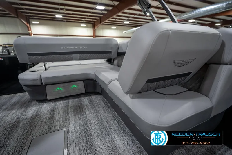 Slide: The Image of 2026 Bennington 26 MSB boat interior with gray seating and flooring in a showroom. - 23