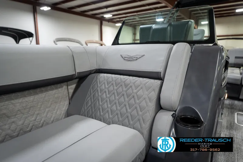 Slide: The Image of 2026 Bennington 26 MSB boat interior with plush seating in a showroom. - 26