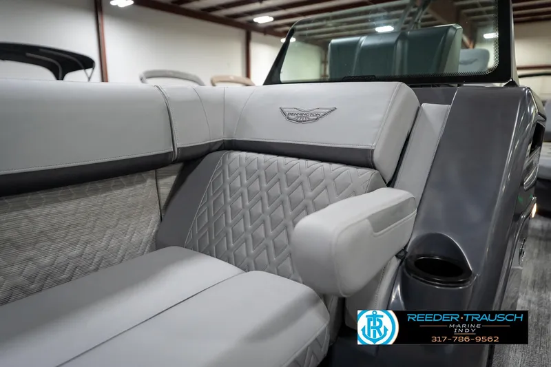 Slide: The Image of 2026 Bennington 26 MSB pontoon boat interior with plush seating in a showroom. - 27