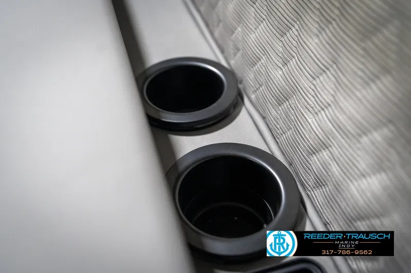 Slide: The Image of Cup holders on a 2026 Bennington 26 MSB boat, featuring textured upholstery. - 49